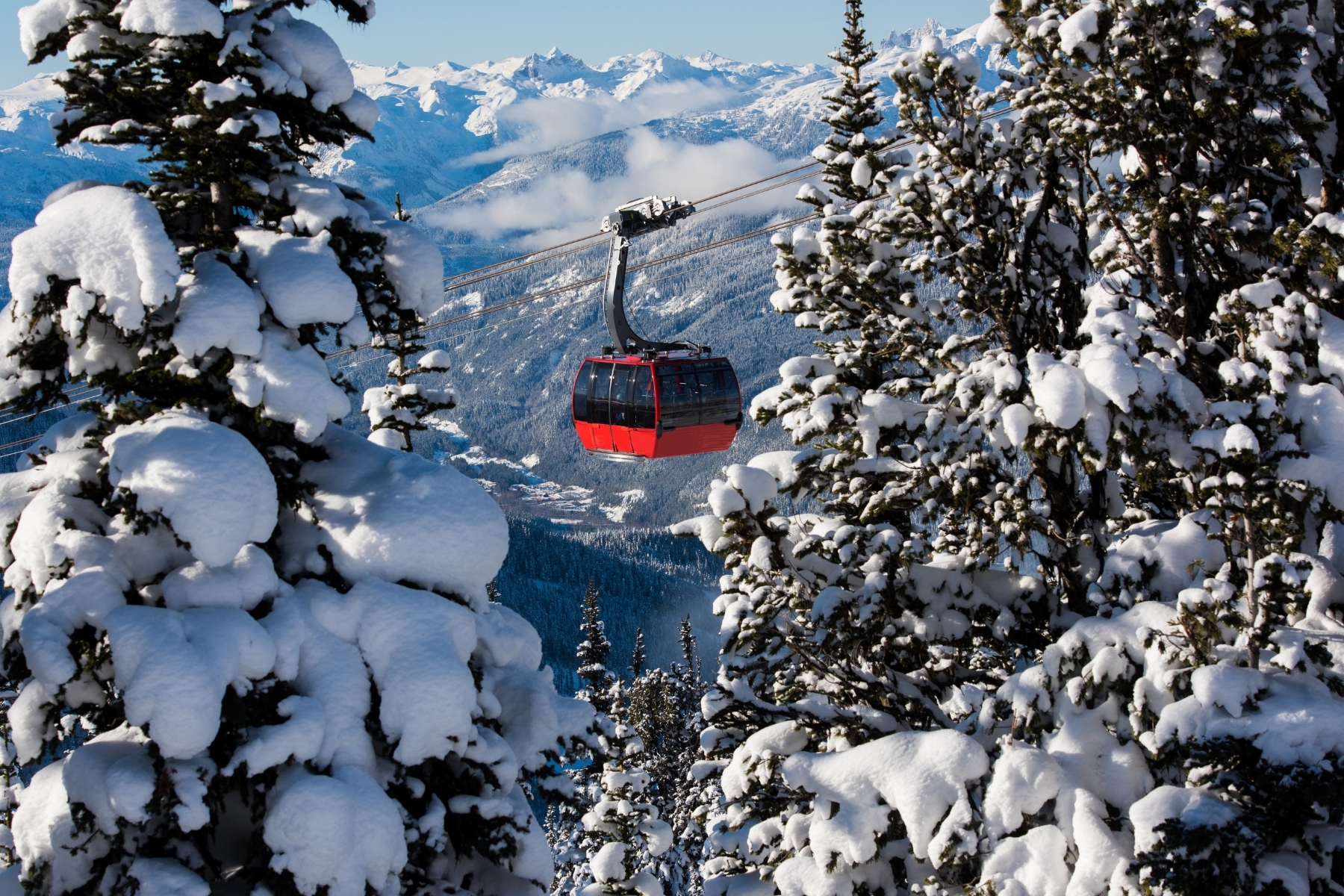 Individual skiing down the mountain with the hotel in the background