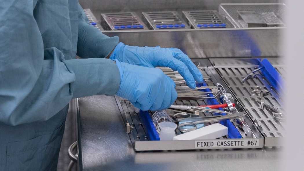Hands working on a instrument kit