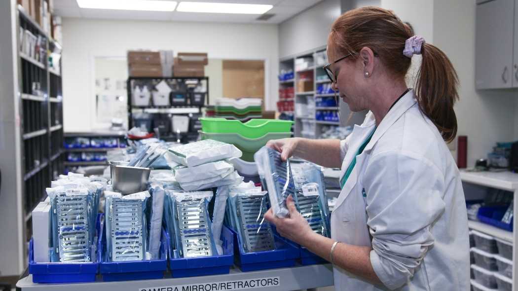 Person in the dispensary looking at sealed kits