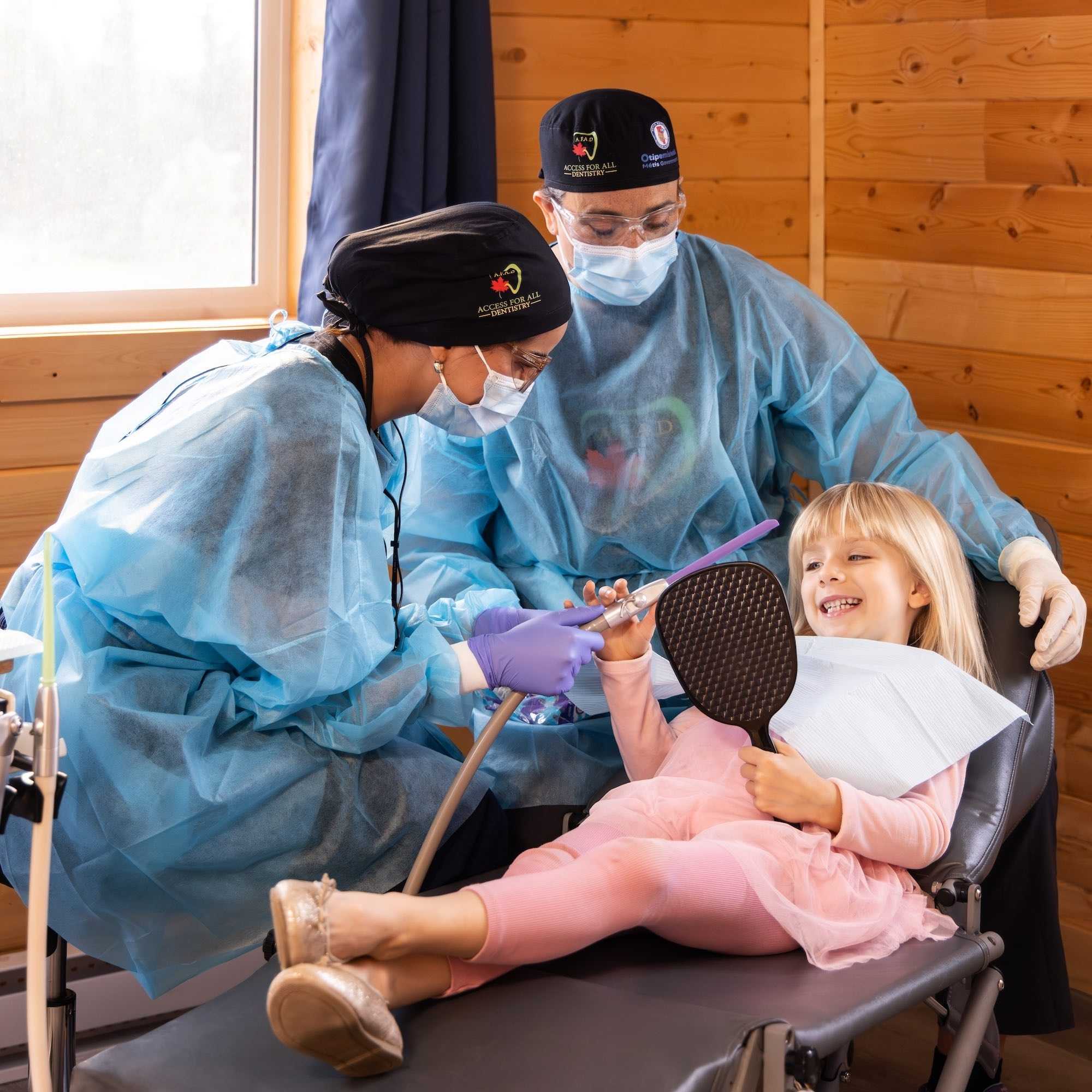 Two students and a patient at an Access for All mobile clinic