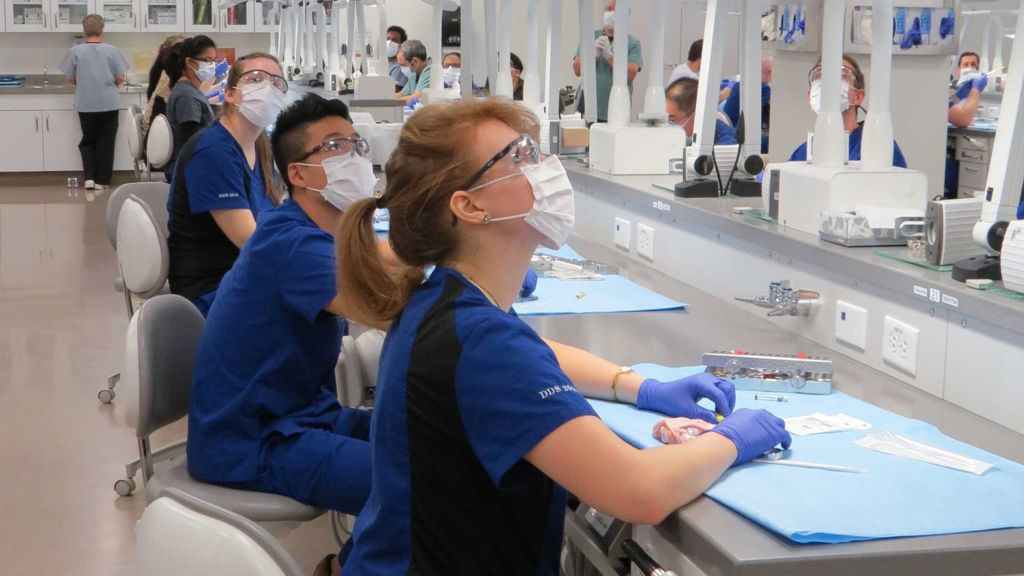 Students sitting in the sim lab looking at the tv screen