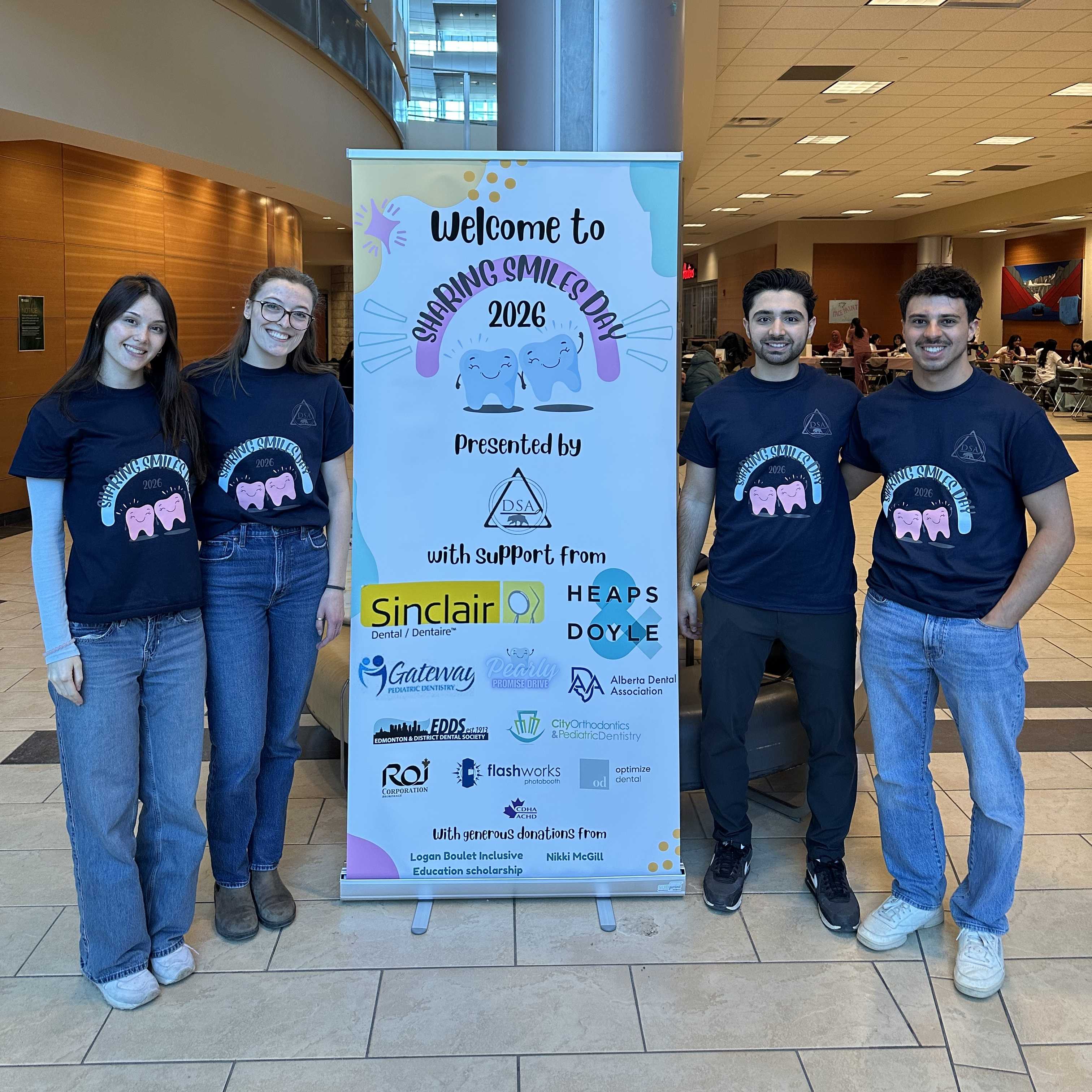 Students standing in front of the banner