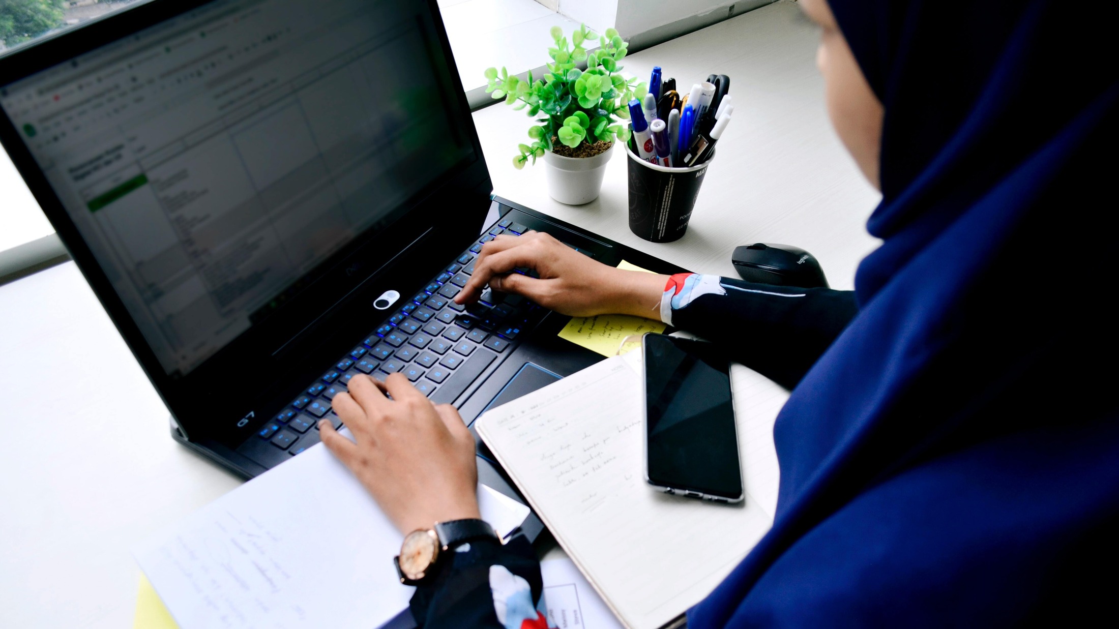 Undergraduate student performing research at a laptop.