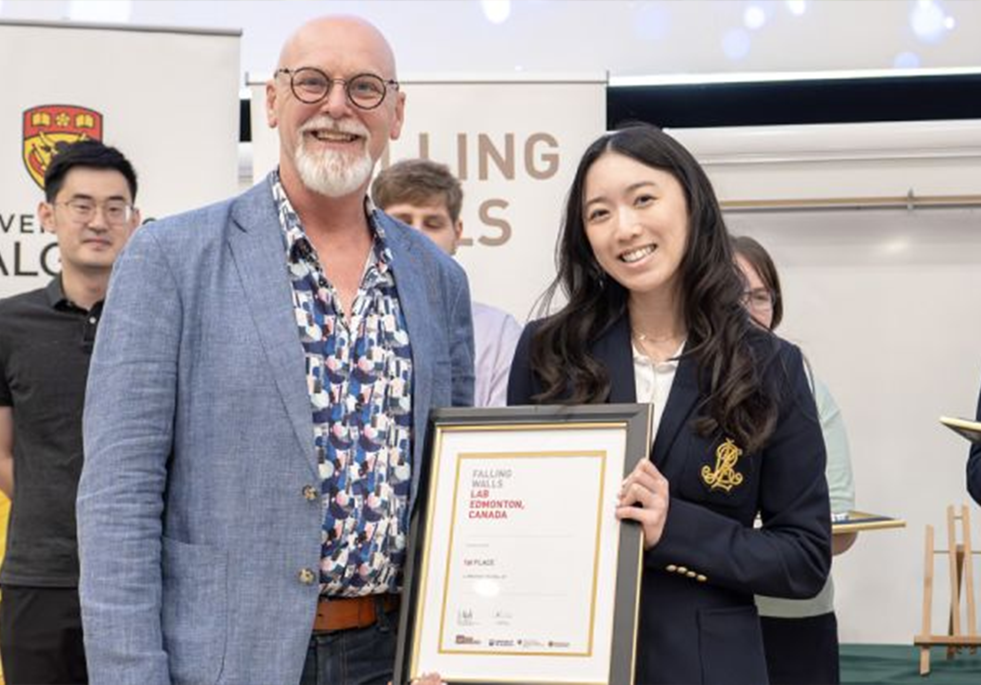 man presenting certificate to a woman