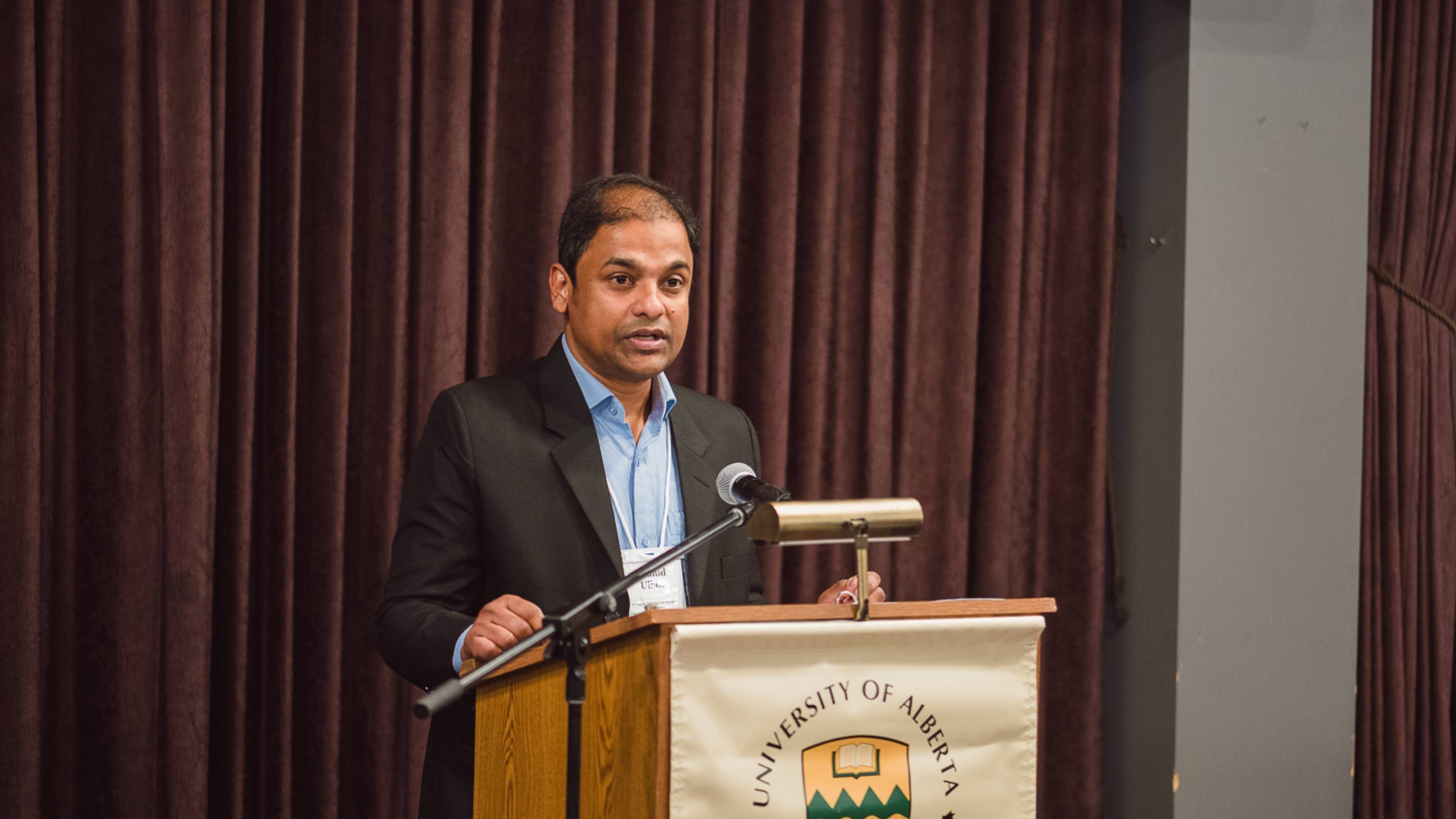 Shahid Ullah, President of the Post Doctoral Fellows Association, congratulates award recipients.