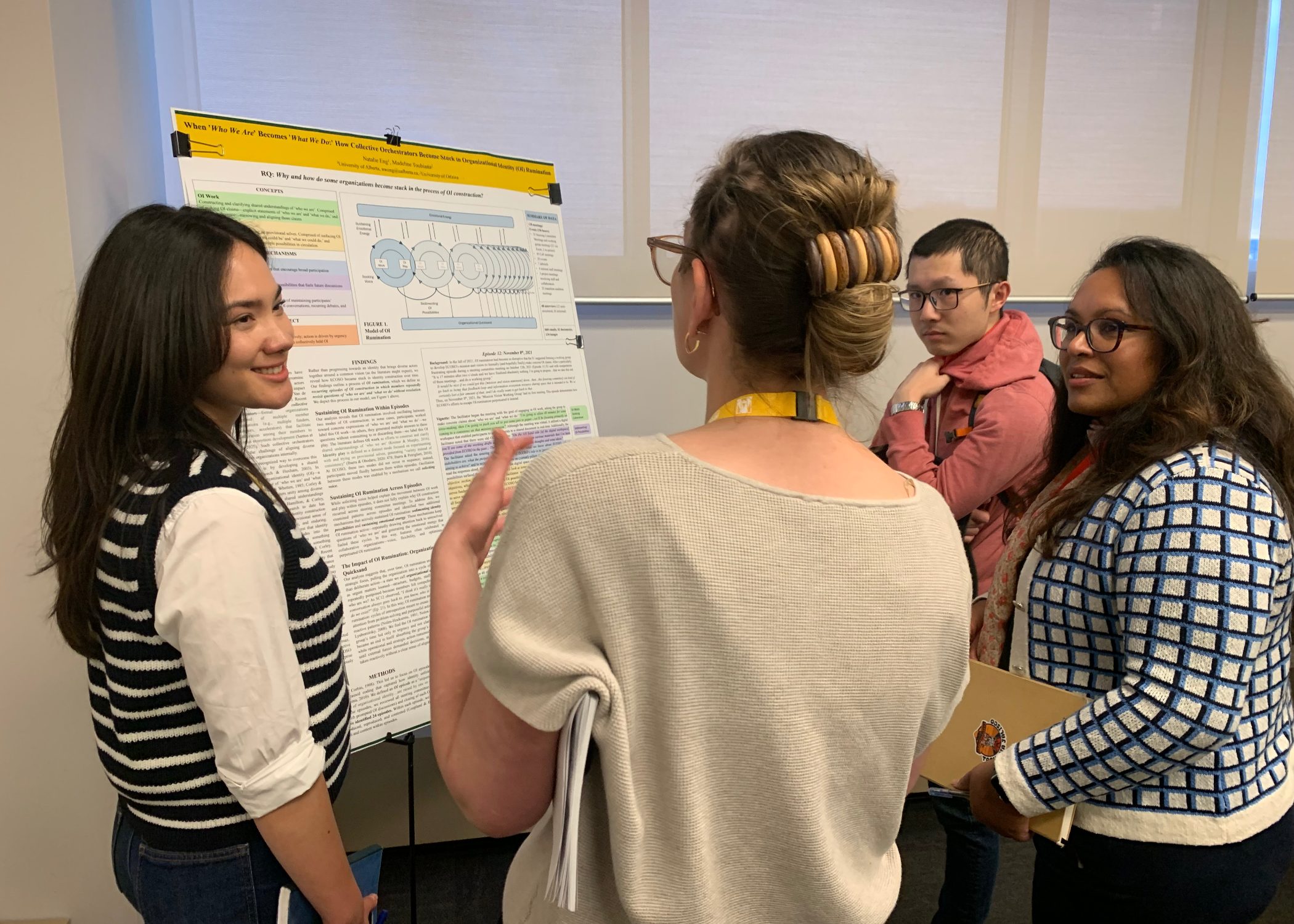 Business PhD Research Conference attendees discuss SEM PhD candidate Natalie Eng’s research findings in the conference poster sessions. 