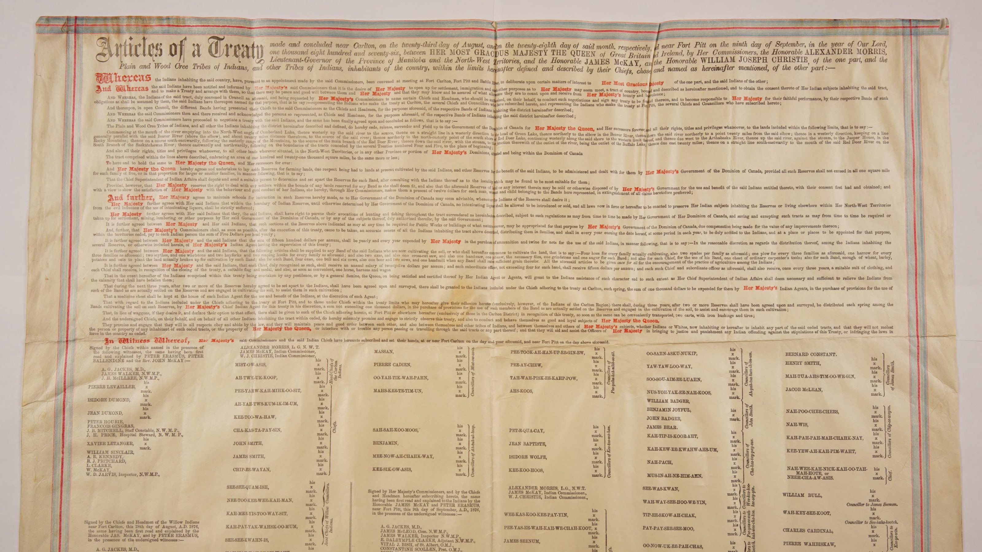 A presentation copy of the original Treaty No. 6 (1876 August 23). Printed on parchment. Text in black and red; blue and red border. Sourced from the University of Alberta Library's Bruce Peel Special Collections.