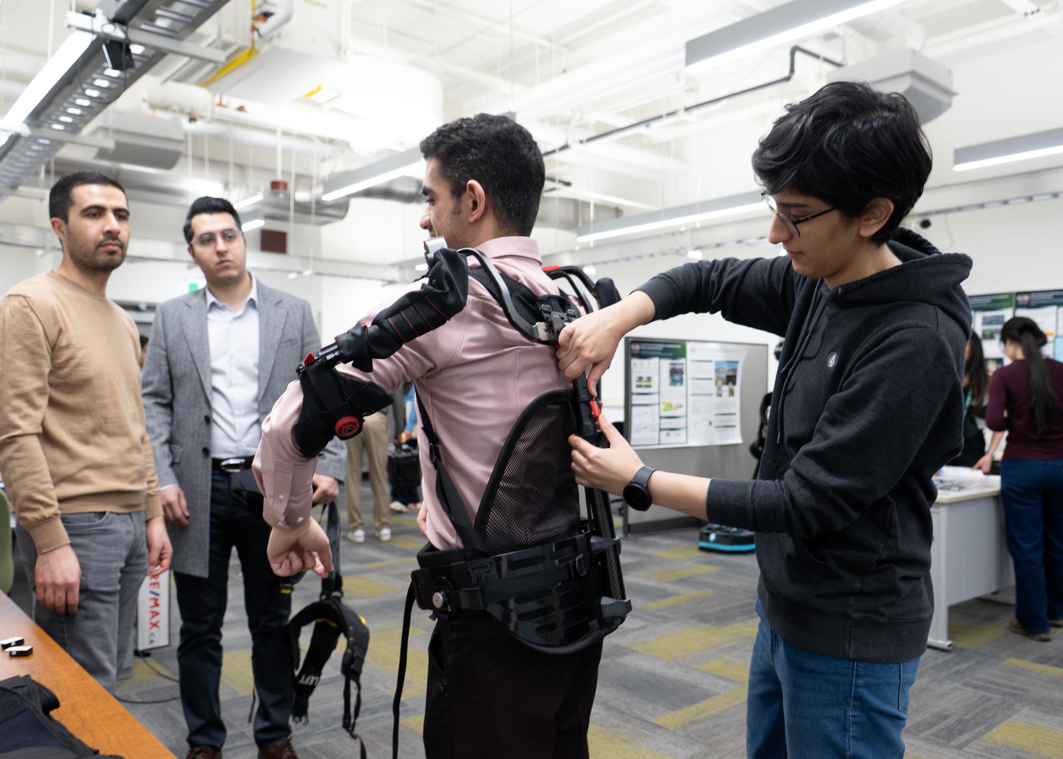 Left to right: graduate teaching assistant Niromand Jasimi, CIC executive director Ali Golabchi, graduate student Mohammad Rezaeiashtiani and graduate teaching assistant Negar Riahi conduct a biomechanical experiment, fitting and calibrating an exoskeleton device.