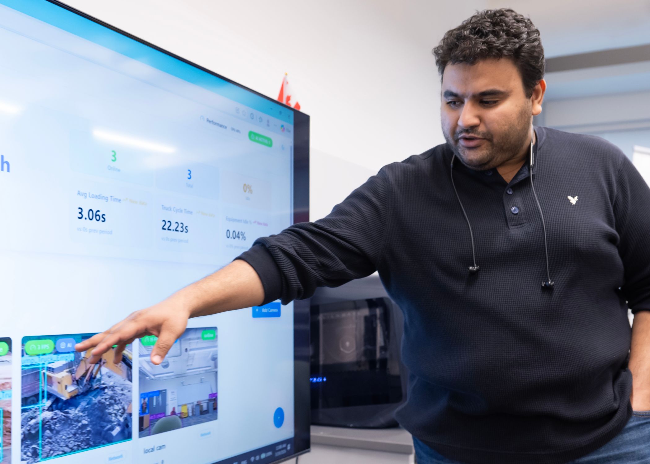 PhD researcher Mohammed Sabek studies computer vision in construction, presenting and analyzing real-time equipment performance data on display.