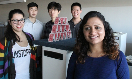 UAlberta chemical engineering PhD graduate Tinu Abraham, right, has found a way to disrupt the electrokinetic forces that keep fine clay particle suspended, like a house of cards, in oilsands tailings.