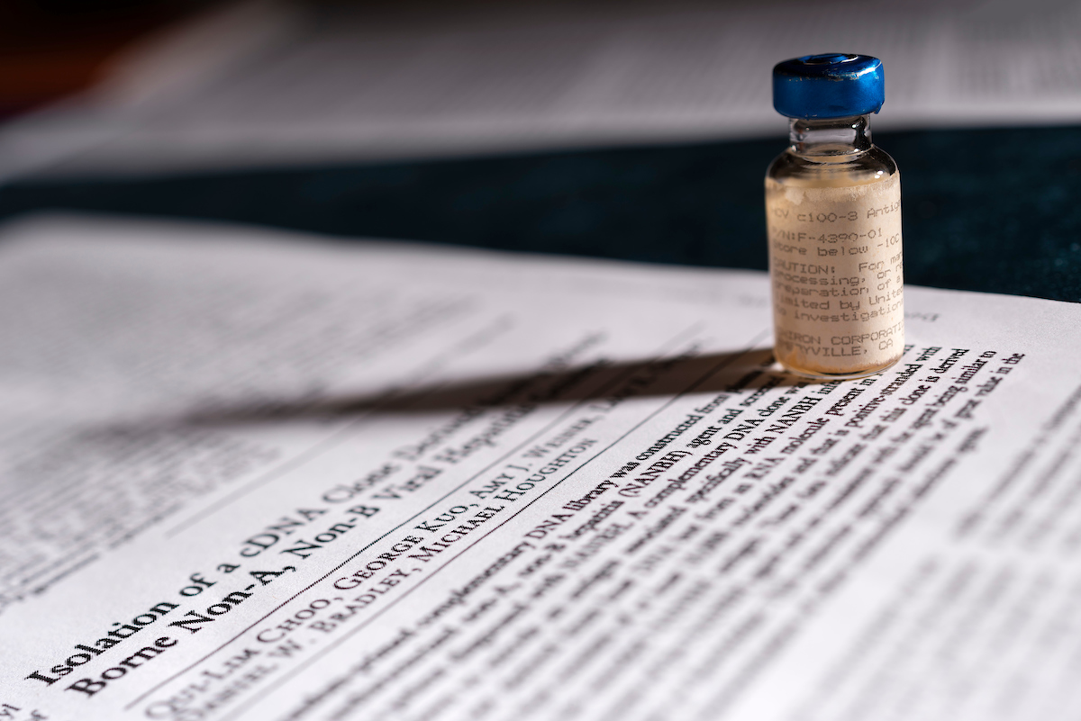 Photo of a vial on top of a research paper