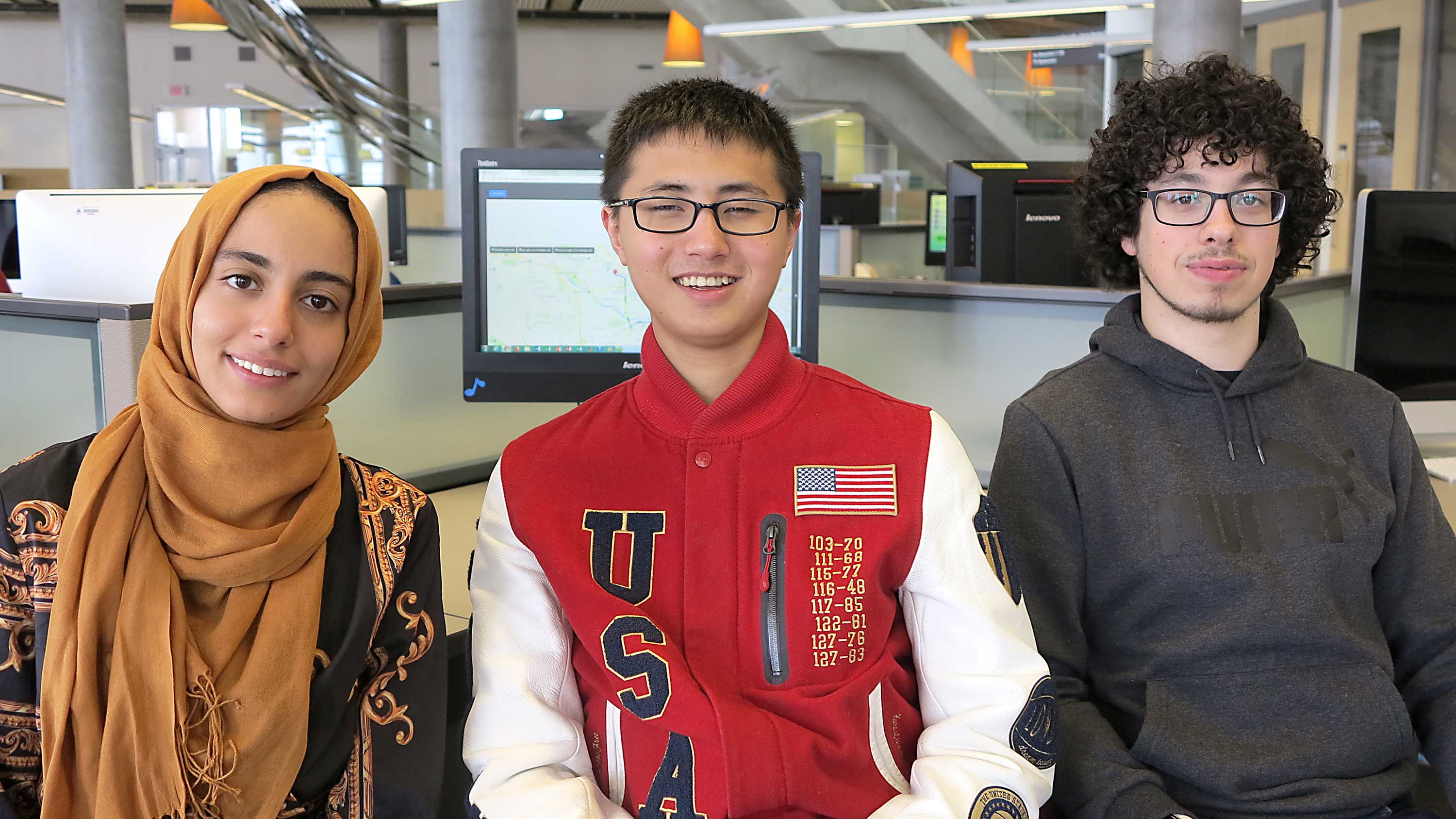 (From left) Fatima Bin Sumait, Peter Zung and Phil Nadon pose in a computer lab