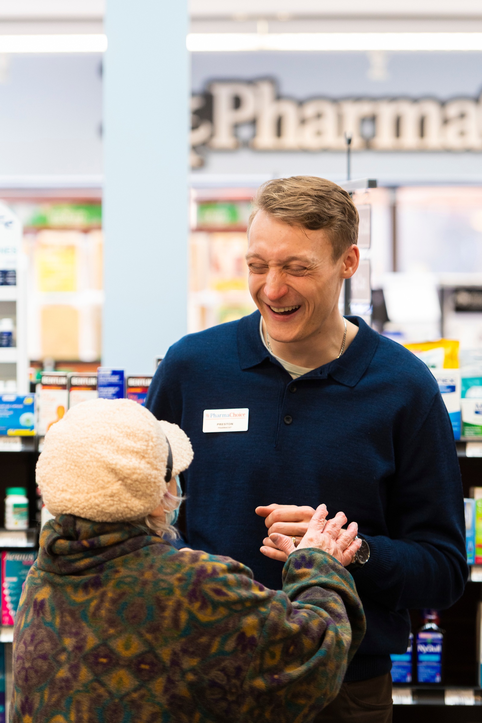 Pharmacy graduate Preston Eshenko laughs with a customer at Gourlay's Pharmacy Banff where he works as a pharmacist. (Photo: John Ulan)