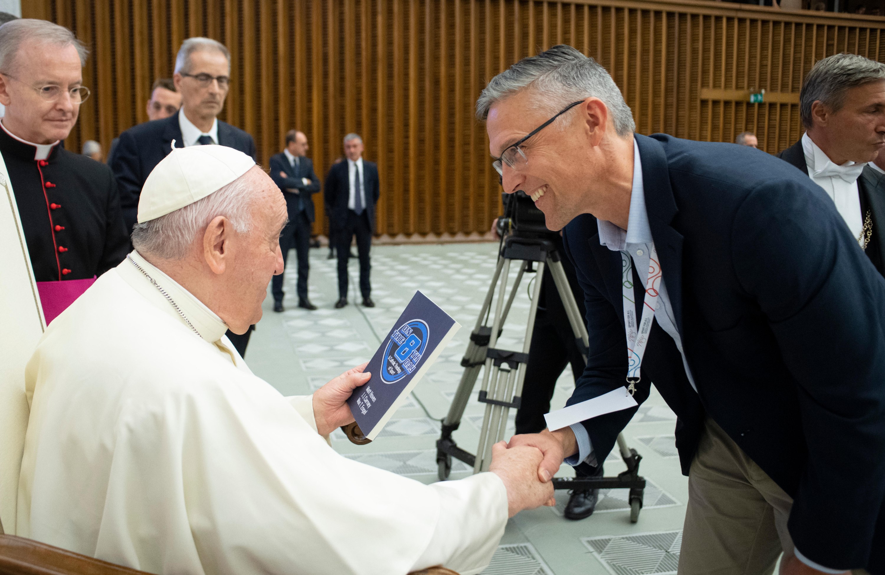 Matt Hoven presents his book to Pope Francis.