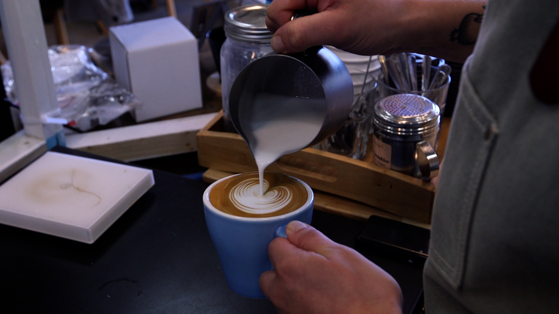 Barista pours a cup of coffee.
