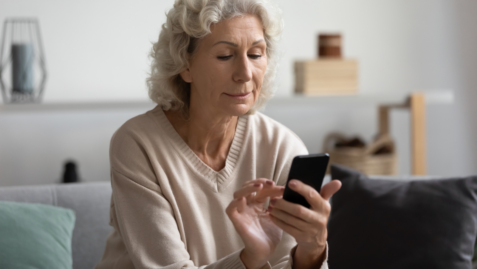 Older woman looks at smartphone. (Photo: Getty Images)