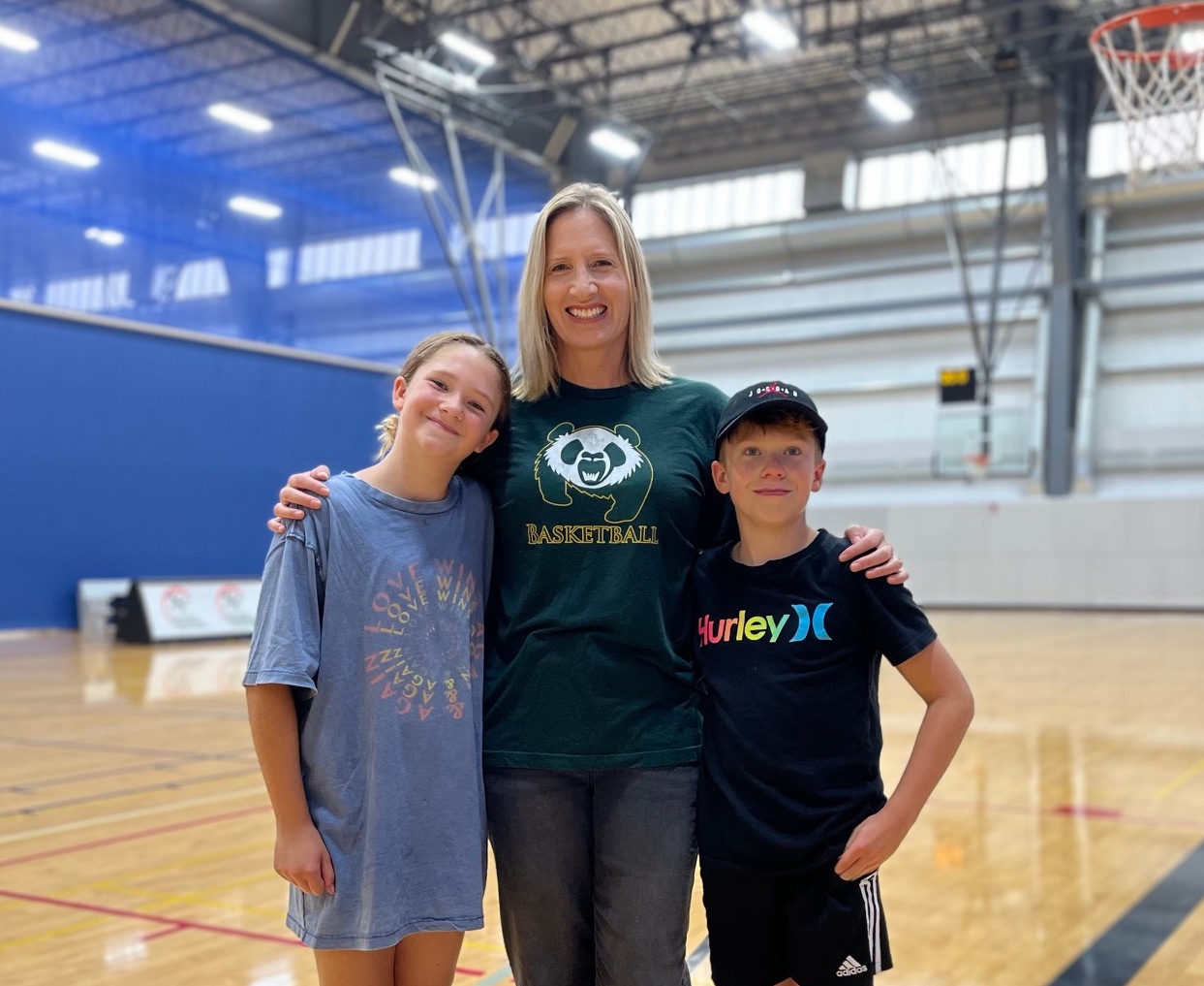 U of A graduate and former Pandas basketball player Kim Hertlein (centre) with her children Kiana (left) and Liam, who are taking part in Green & Gold Summer Camps