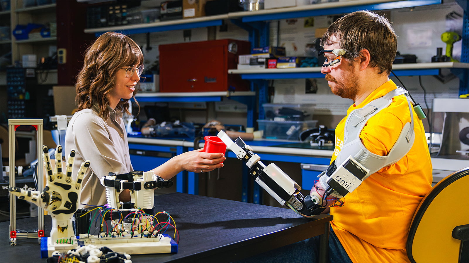 Research associate and biomedical engineering graduate Quinn Boser works with a prosthesis user in the Bionic Limbs for Improved Natural Control (BLINC) laboratory at the University of Alberta.