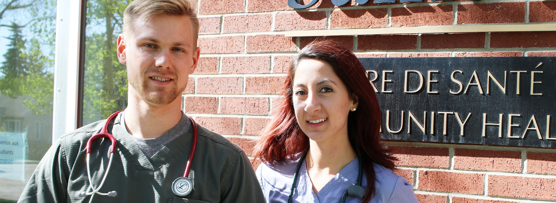 Two nursing students in front of Centre de Santé Saint-Thomas