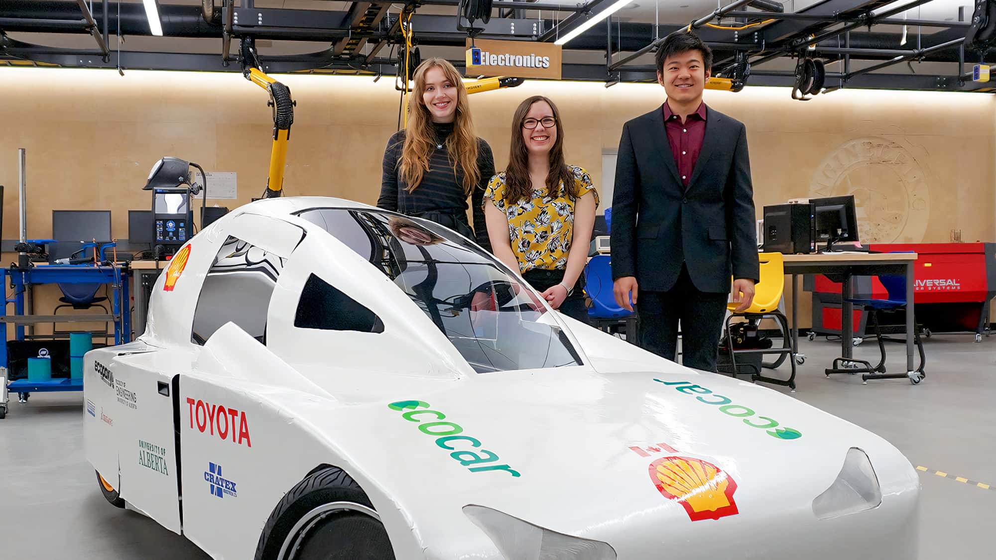 Engineering students standing by their EcoCar project
