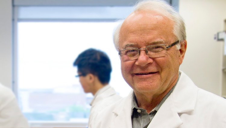 Nobel Prize winner Michael Houghton wearing a lab coat