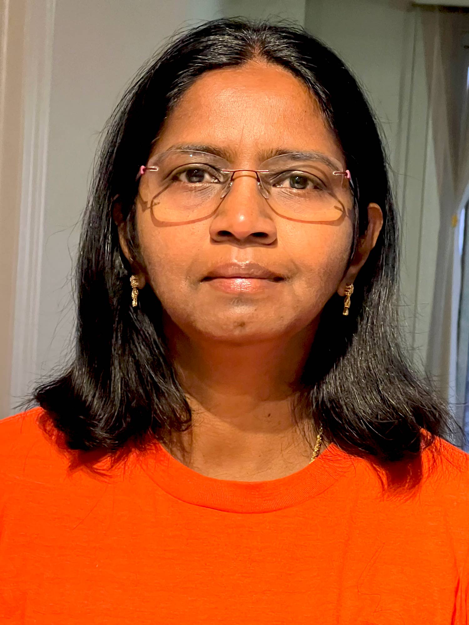 Shanthi Johnson wearing an orange shirt