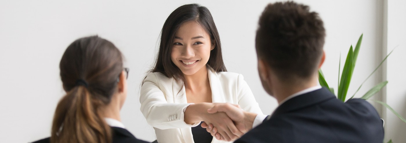 woman shaking hands in a meeting