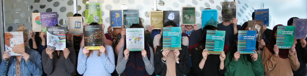 Group of people holding up textbooks in front of their faces