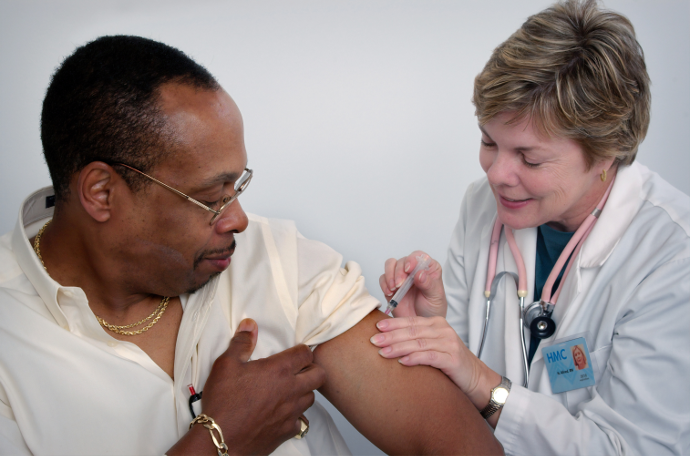 A healthcare worker gives a patient an injection.