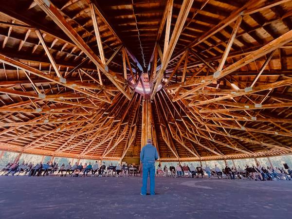Photo of Elder Rick Lightning under the wooden arbour at Enoch Cree Nation.