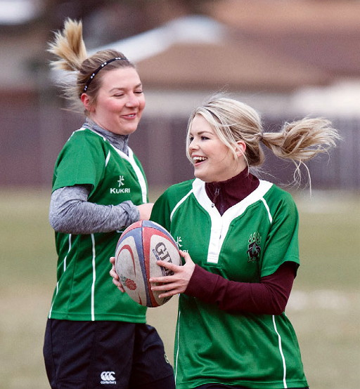 Two girls playing rugby