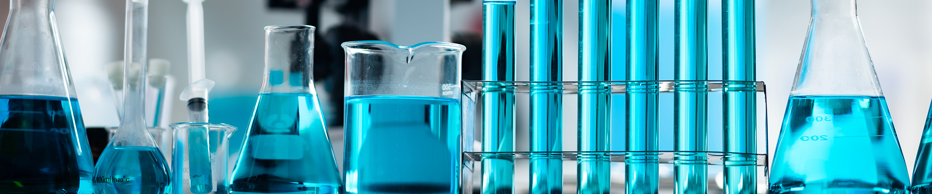 Various lab containers filed with blue liquid