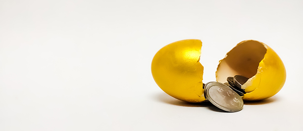 A cracked golden egg with coins spilling out.