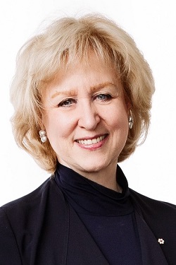 Headshot of Kim Campbell standing and smiling