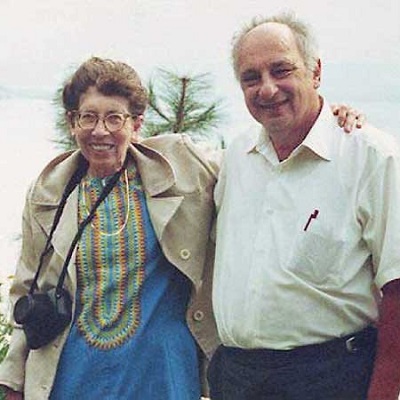 Drs. Josephine Mitchell (left) and Lowell Schoenfeld (right) on vacation with their arms around each other.