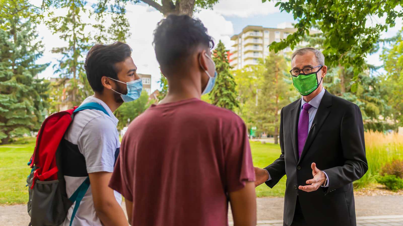 President Bill Flanagan talks with students outside on North Campus.