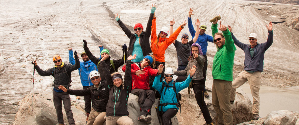 Group of people in climbing gear celebrating.