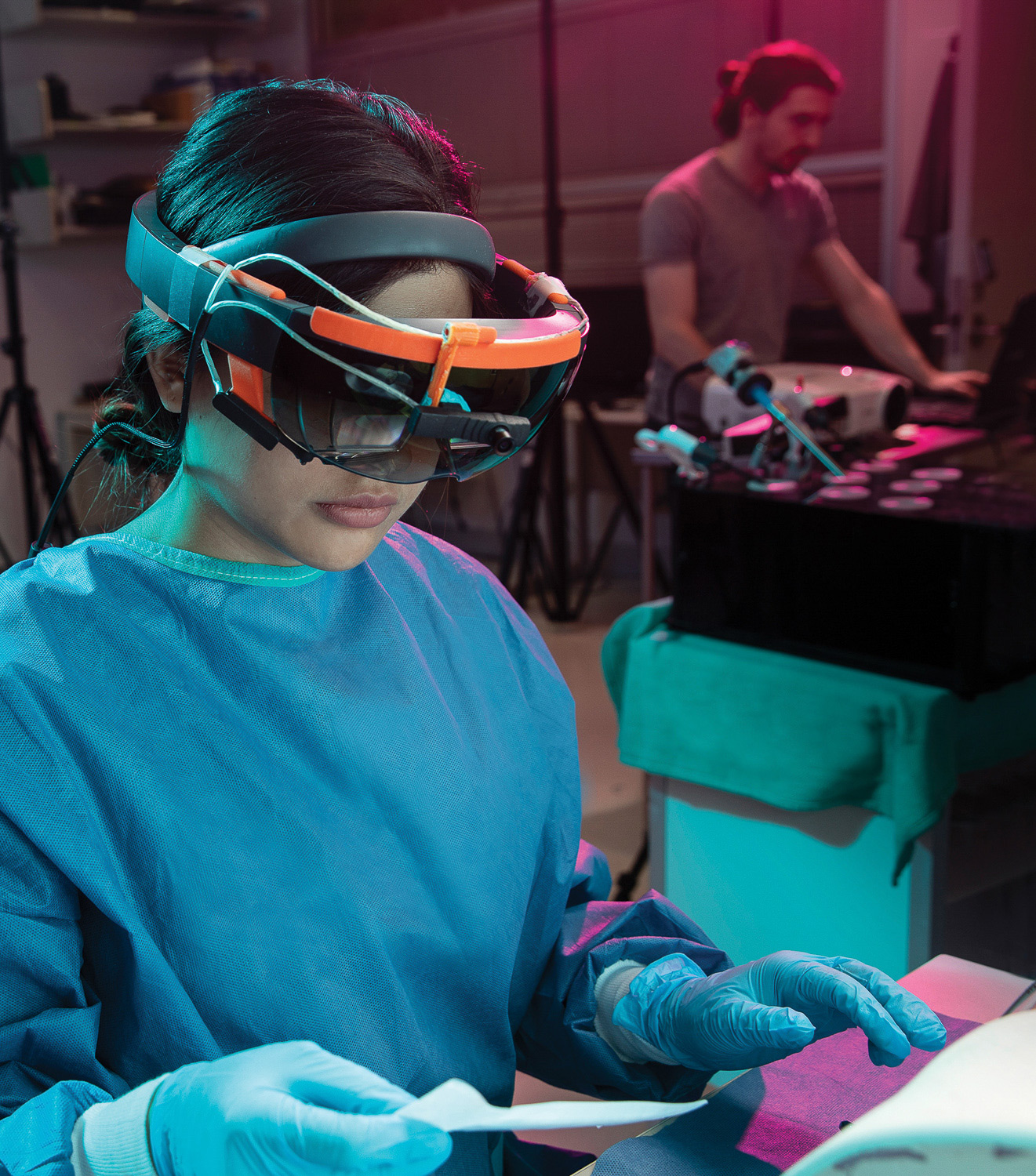 Poala Sanchez, graduate student in surgical education, wears an augmented reality HoloLens device that displays instructions for performing a surgical task. (photos by Laughing Dog)