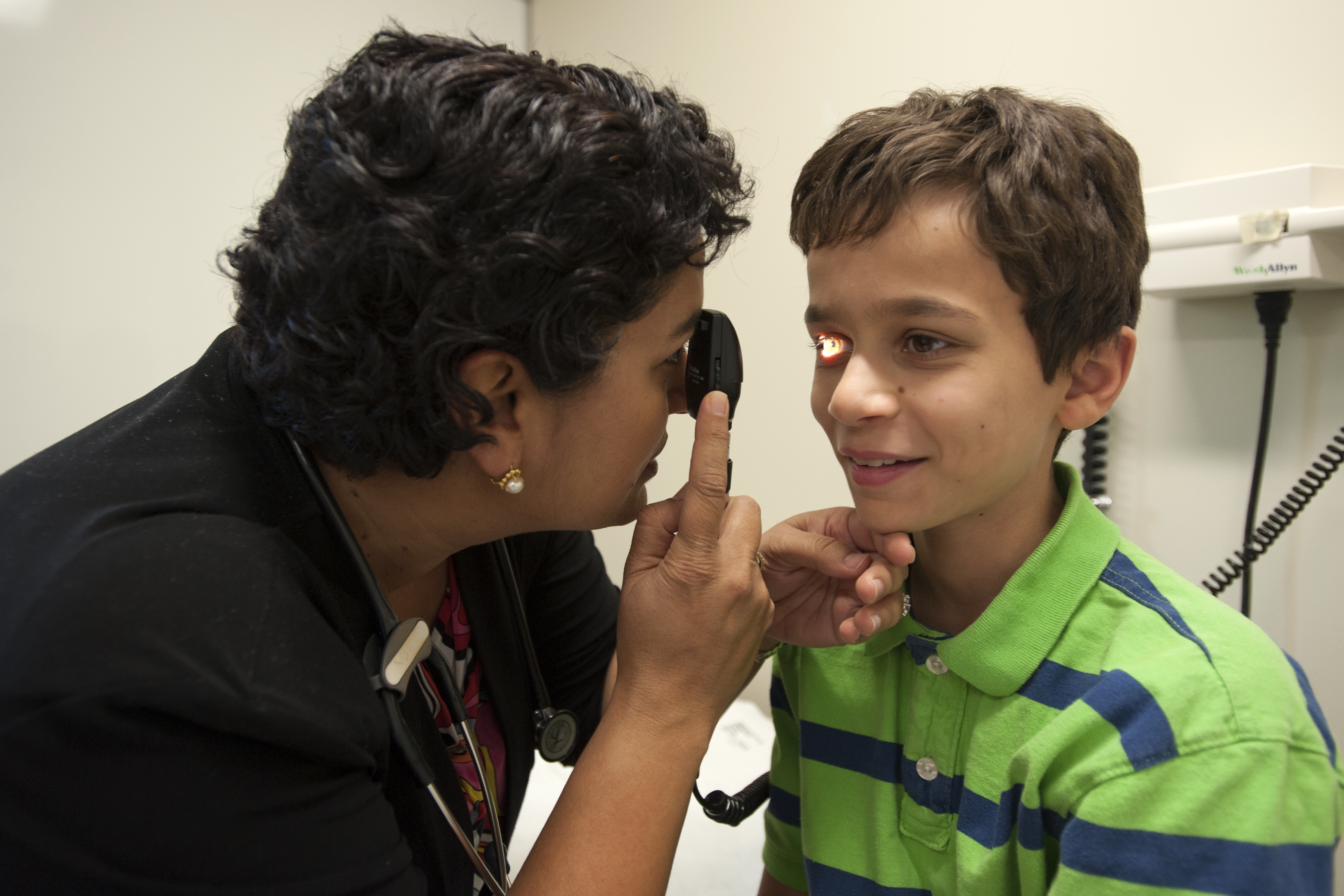 Dr. Vohra inspects a pediatric patient's eye