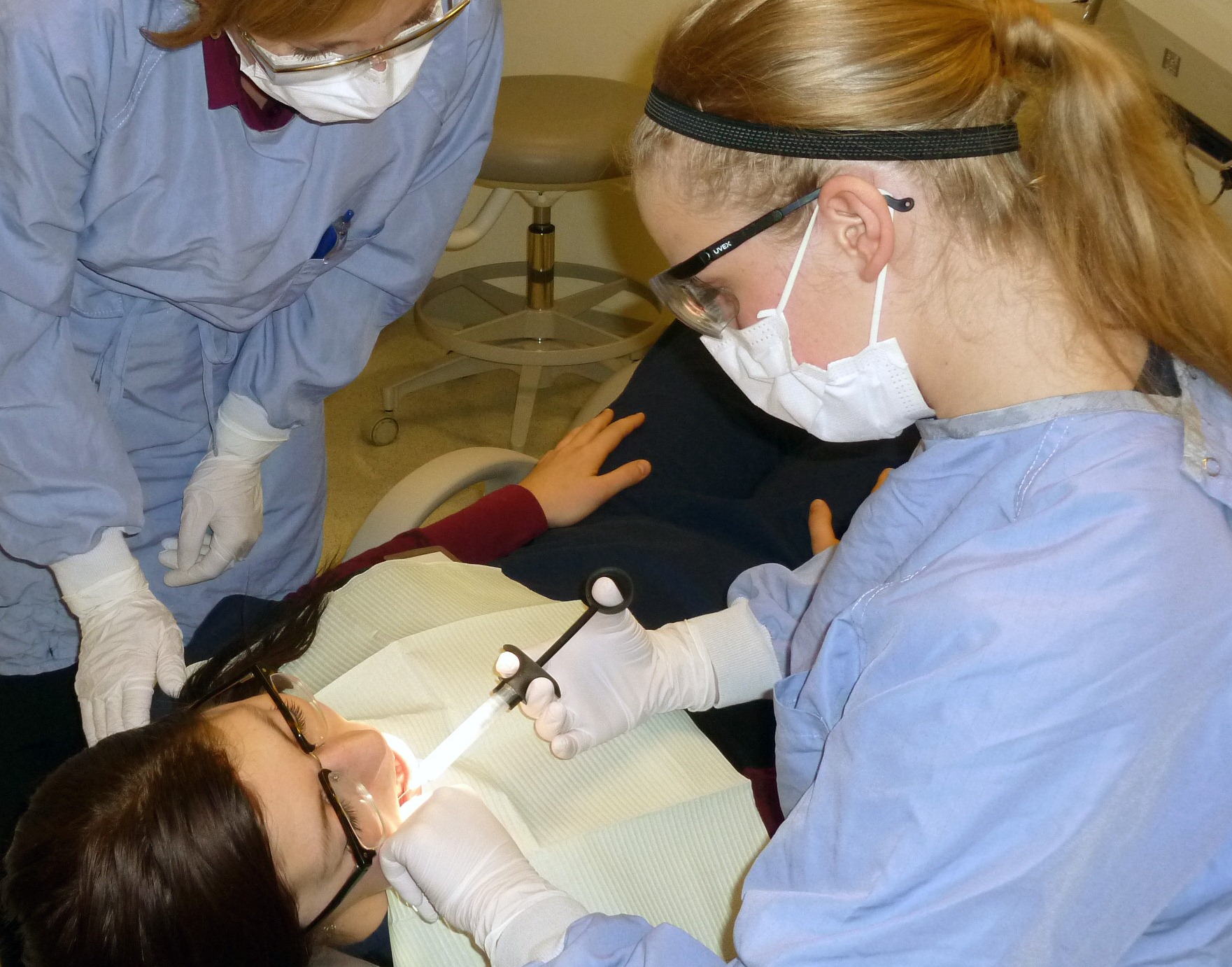 Dental Hygiene students work on a patient