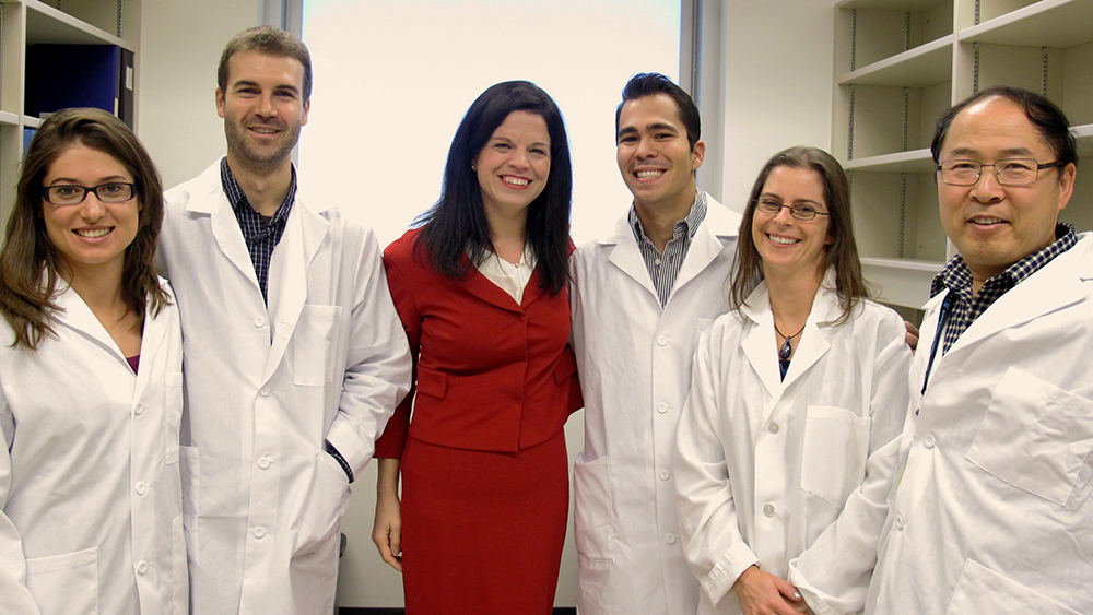 Dr. Lynne Postovit, centre, with her research lab.
