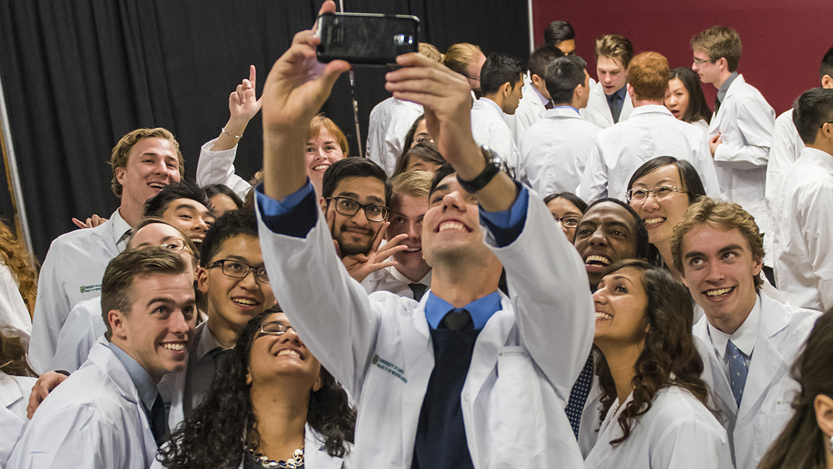 Students take a selfie at the Dean's White Coat Ceremony
