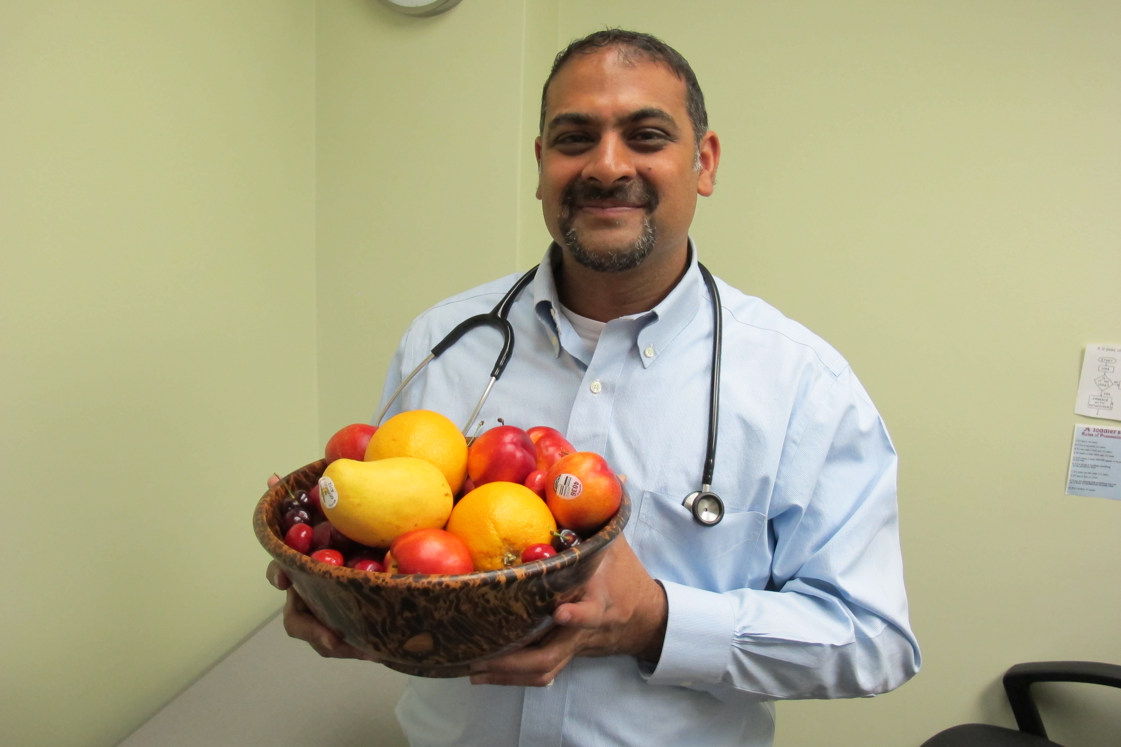 Piush Mandhane holds a bowl of fruit