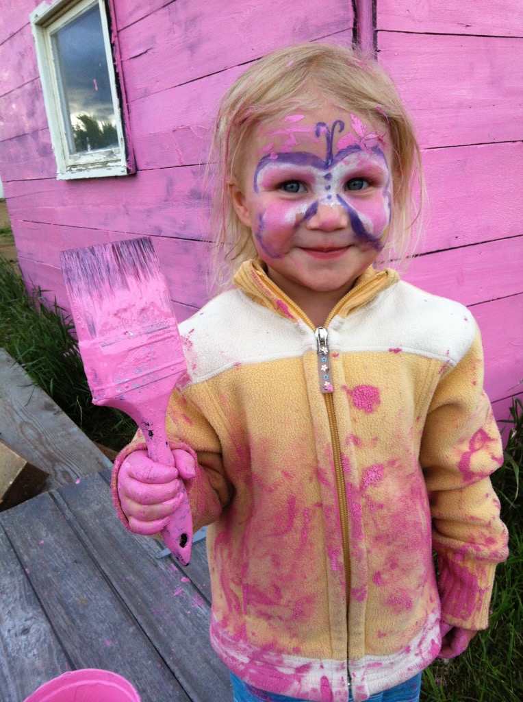 A child helps paint the town pink for Wild Pink Yonder