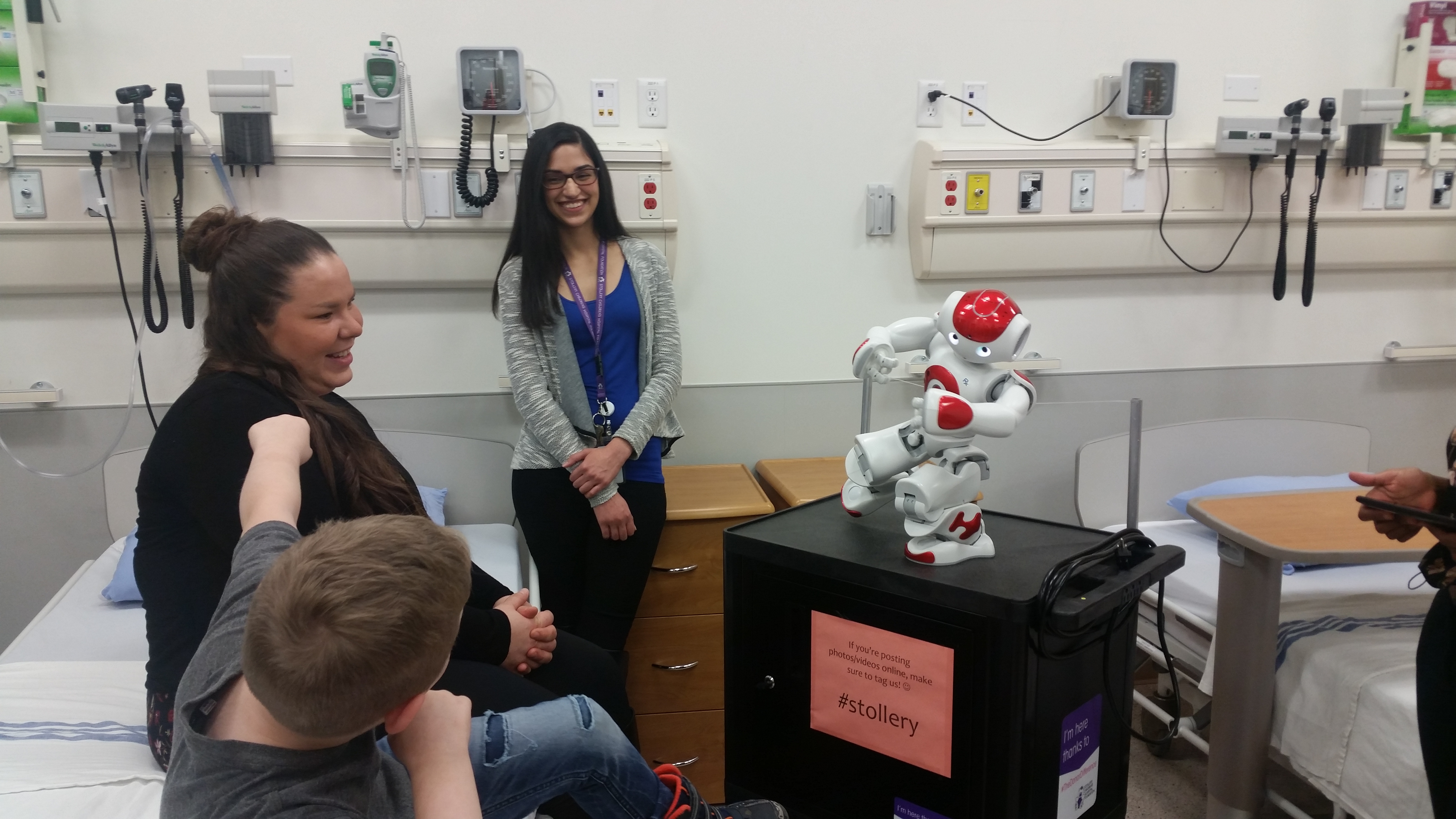 Family in hospital room with a medical robot
