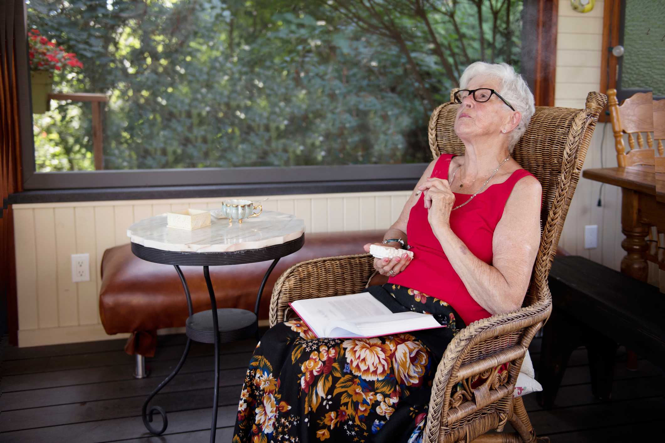 Older woman in a chair smoking cannabis