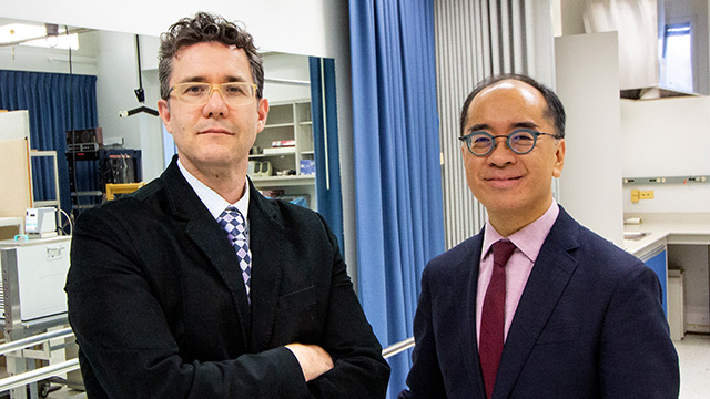 Adalberto Loyola-Sanchez and Chester Ho standing in a lab