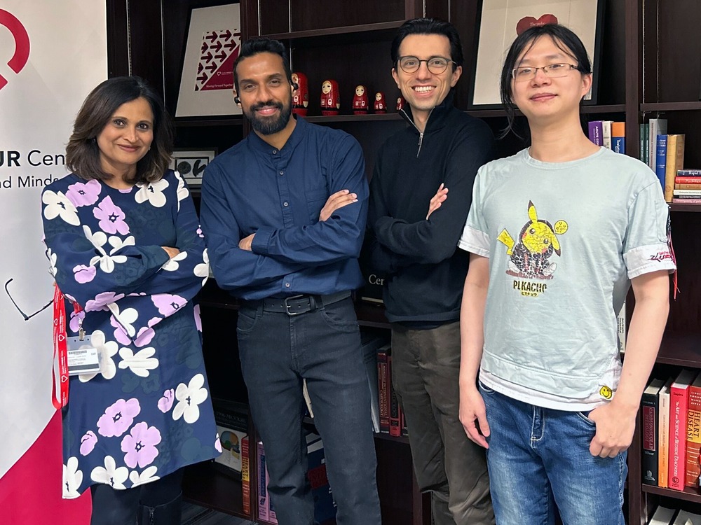 From left to right: Padma Kaul, Sunil Kalmady Vasu, Nariman Sepehrvand, and Weijie Sun pose in front of a bookshelf and a Canadian VIGOUR Centre banner.
