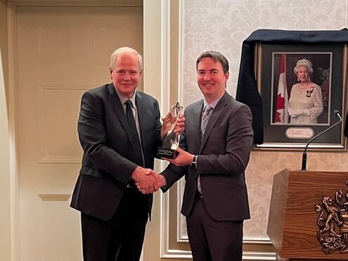 Minister Jason Copping presents Dr. Keith Aronyk with the Lifetime Achievement in Health award at Government House.