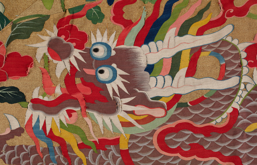 A dragon embroidered into a textile